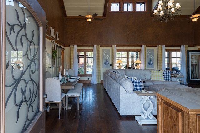 living room featuring high vaulted ceiling, dark hardwood / wood-style floors, and ceiling fan with notable chandelier