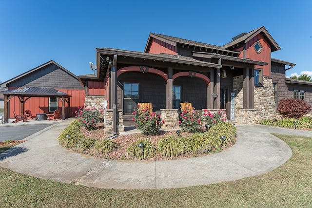 view of front of home with a front yard and covered porch