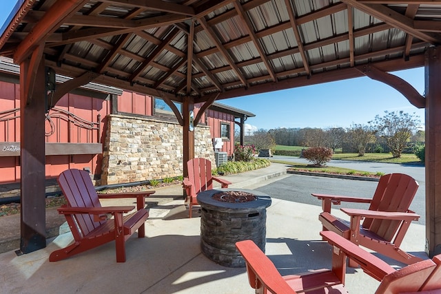 view of patio with an outdoor fire pit and a gazebo