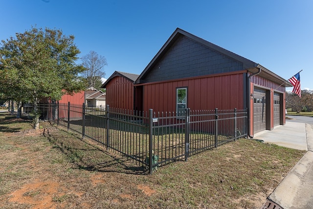 view of property exterior with an outdoor structure, a yard, and a garage