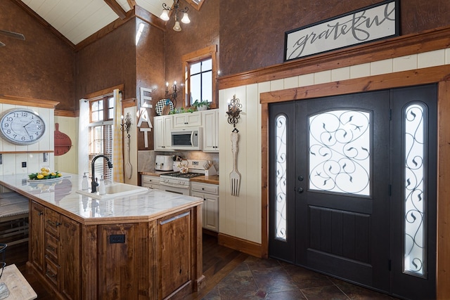 45 Bent Grass Cir, Hayesville, NC 28904 - kitchen featuring white appliances, a sink, high vaulted ceiling, white cabinets, and decorative backsplash