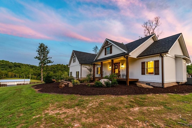 view of front of house featuring a yard and covered porch