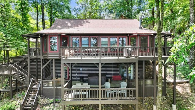 rear view of house featuring a wooden deck