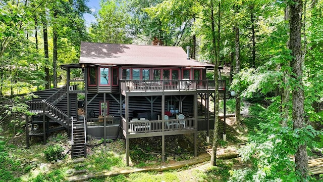 rear view of house featuring a wooden deck