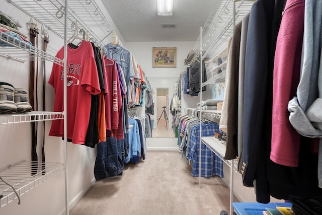 walk in closet featuring carpet floors and visible vents