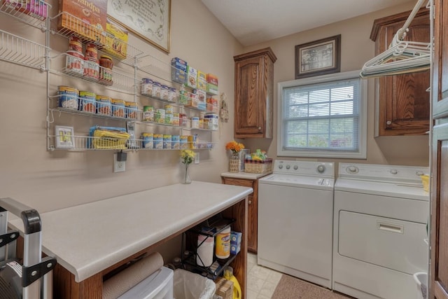 laundry area with light floors, cabinet space, and washing machine and clothes dryer