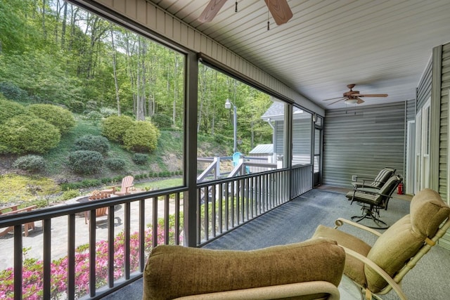 sunroom featuring ceiling fan
