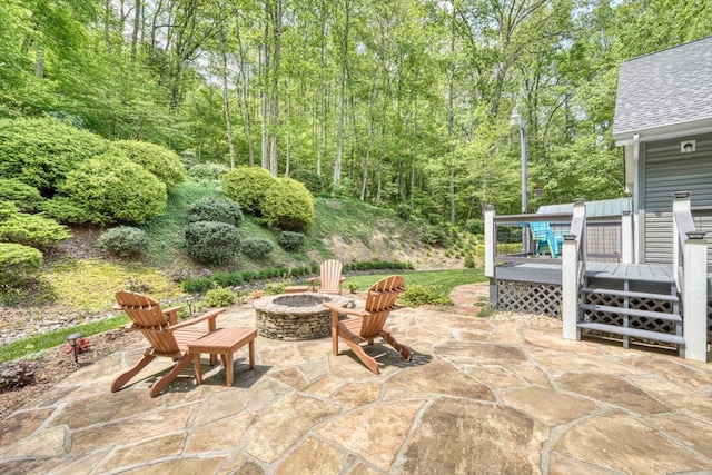 view of patio / terrace featuring an outdoor fire pit and a deck