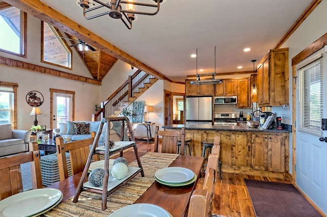 dining room featuring a notable chandelier, vaulted ceiling with beams, recessed lighting, wood finished floors, and stairs