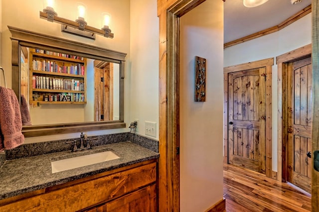 bathroom with wood finished floors and vanity