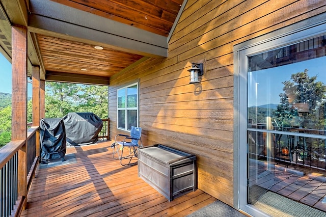 wooden terrace featuring a grill