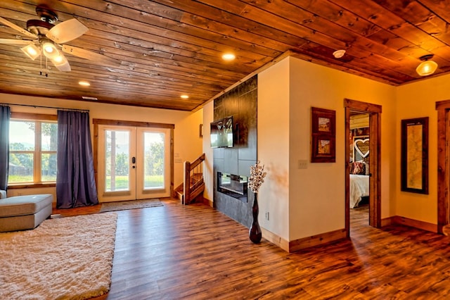 interior space with wood ceiling, a fireplace, wood finished floors, and french doors