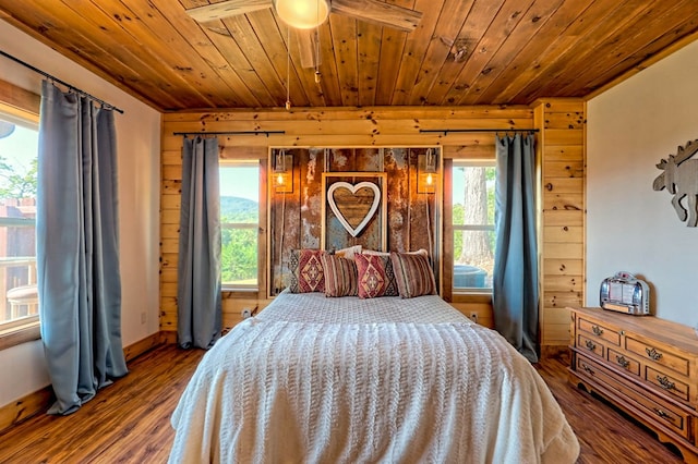 bedroom featuring wooden ceiling, baseboards, and wood finished floors