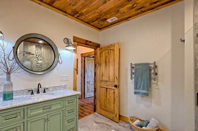 bathroom with wood ceiling, visible vents, baseboards, and vanity