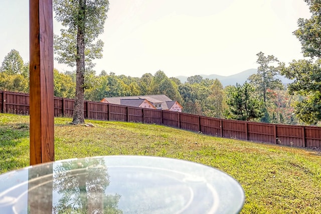 view of yard with fence and a mountain view