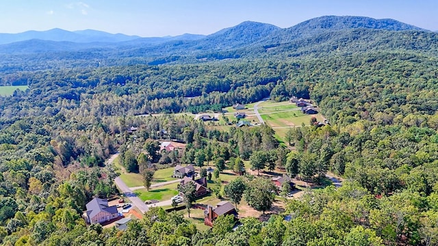 birds eye view of property with a mountain view and a wooded view