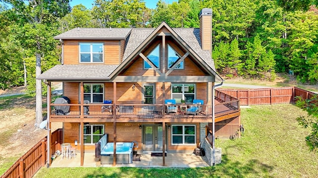 back of property featuring a fenced backyard, a patio, a chimney, and a lawn