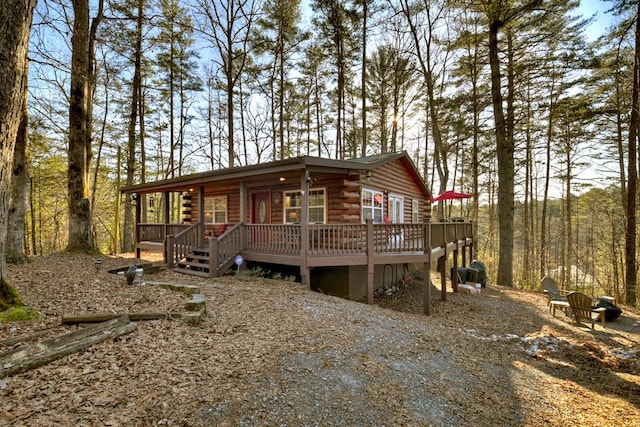 view of front of property featuring a wooden deck and an outdoor fire pit