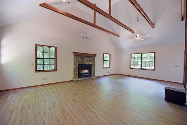 unfurnished living room with a fireplace, hardwood / wood-style floors, a wall mounted air conditioner, high vaulted ceiling, and ceiling fan