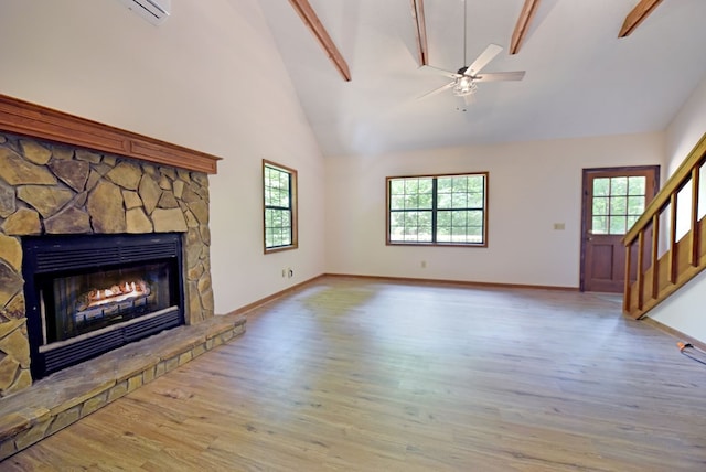 unfurnished living room featuring a fireplace, ceiling fan, hardwood / wood-style flooring, high vaulted ceiling, and beamed ceiling