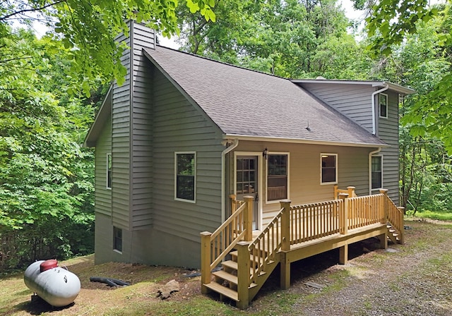 back of property featuring a wooden deck