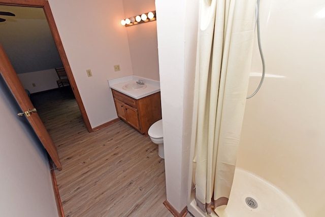 bathroom featuring a shower with curtain, hardwood / wood-style flooring, and vanity