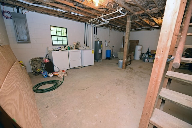 basement featuring electric water heater and washing machine and clothes dryer