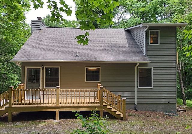 rear view of house featuring a wooden deck