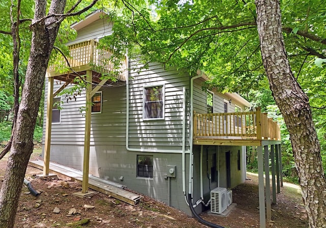 back of house with central AC and a wooden deck