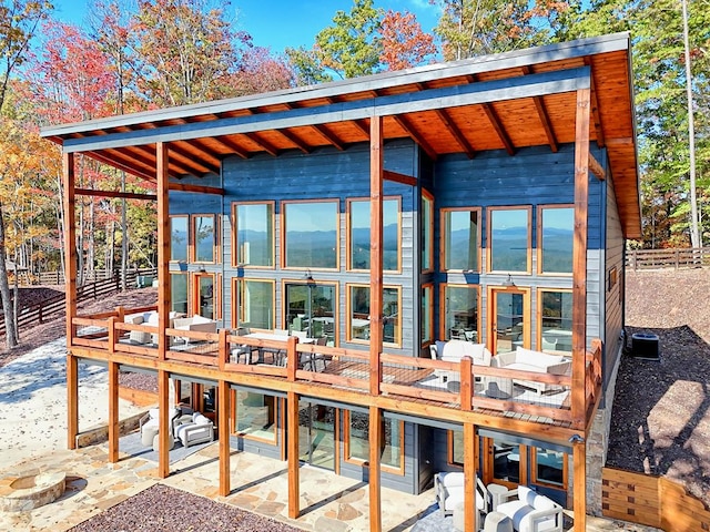 wooden deck with fence and a patio
