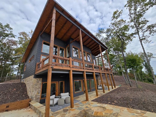 back of house with a patio area and a deck