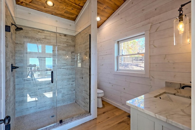 bathroom featuring toilet, a shower stall, wood walls, wood ceiling, and wood finished floors