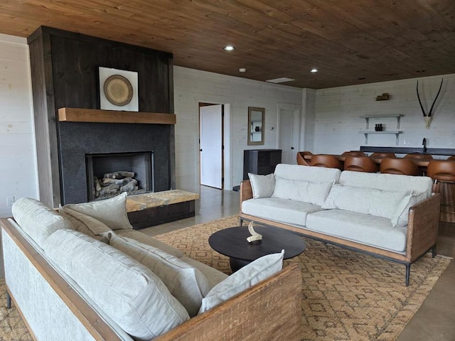 living room with concrete floors and wooden ceiling