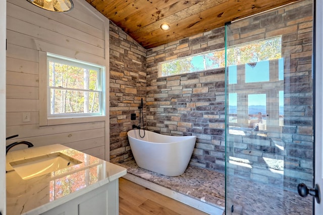full bathroom featuring a shower stall, vaulted ceiling, wooden ceiling, wood finished floors, and a freestanding bath