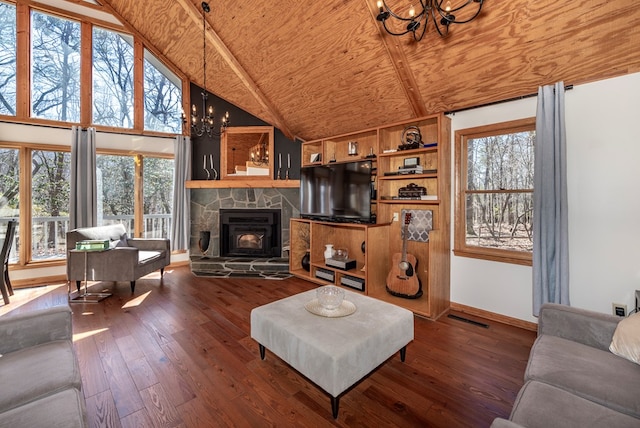 living room featuring a wealth of natural light, hardwood / wood-style floors, wood ceiling, and a notable chandelier