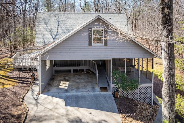 garage with driveway and a carport