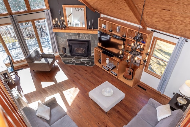 living room featuring visible vents, a chandelier, and wood finished floors