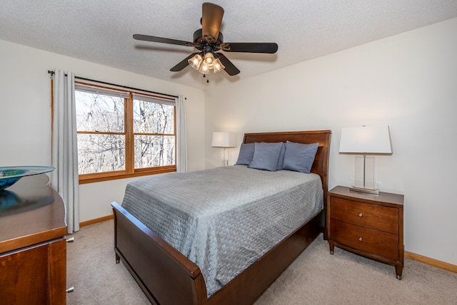 bedroom featuring baseboards, a textured ceiling, and light colored carpet