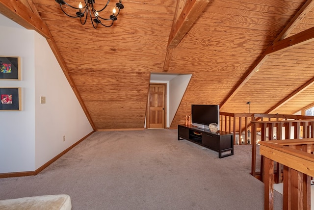 unfurnished living room with a chandelier, baseboards, carpet flooring, and lofted ceiling