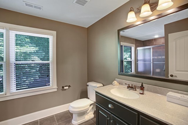 bathroom featuring vanity, tile patterned floors, walk in shower, and a healthy amount of sunlight