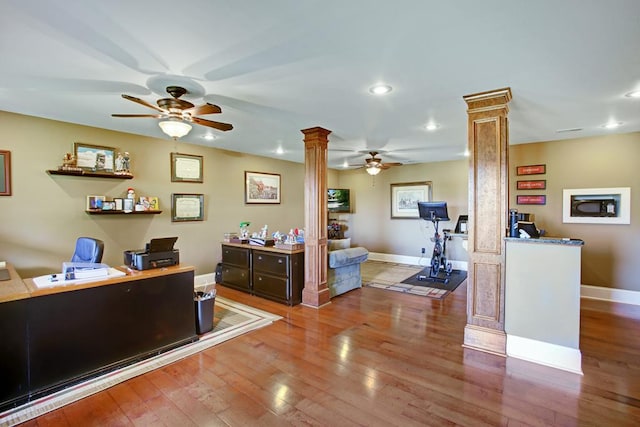 office with hardwood / wood-style floors and ornate columns