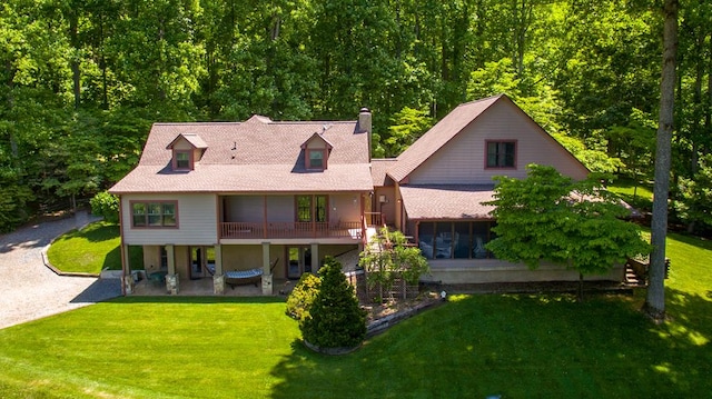 rear view of property with a patio area and a yard