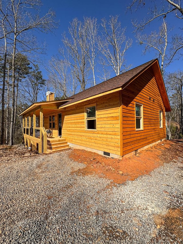 view of side of home featuring covered porch