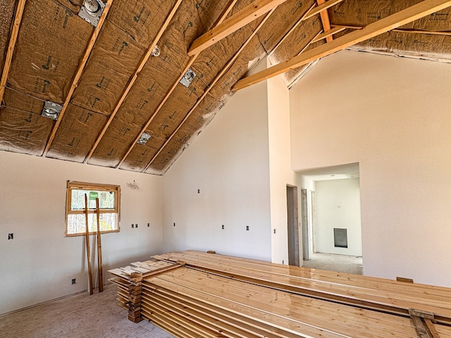 unfurnished room featuring vaulted ceiling