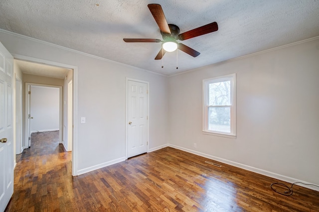 unfurnished bedroom featuring a textured ceiling, wood finished floors, visible vents, baseboards, and ornamental molding