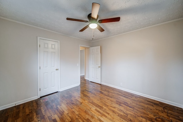 unfurnished bedroom featuring ornamental molding, a textured ceiling, baseboards, and wood finished floors