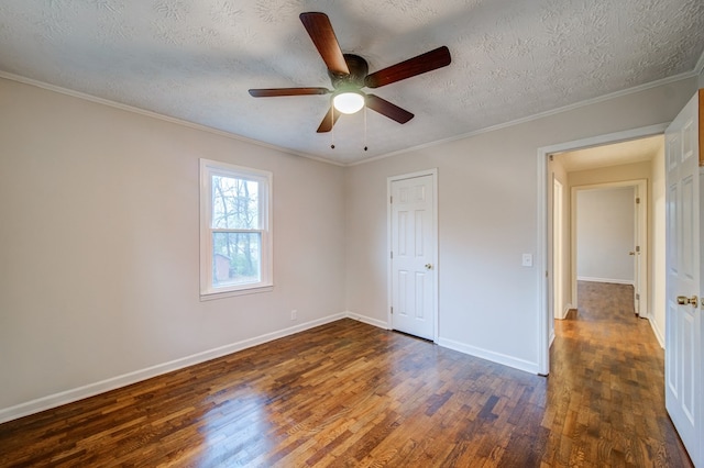 unfurnished bedroom featuring baseboards, ceiling fan, wood finished floors, crown molding, and a textured ceiling