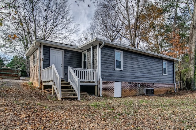 exterior space featuring central AC unit and a deck