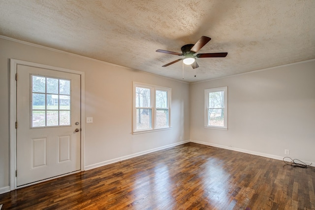 interior space with a textured ceiling, dark wood-style flooring, a ceiling fan, and crown molding