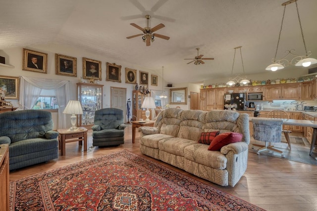 645 E Double Knob Dr, Hayesville, NC 28904 - living area with vaulted ceiling, a ceiling fan, and light wood-style flooring